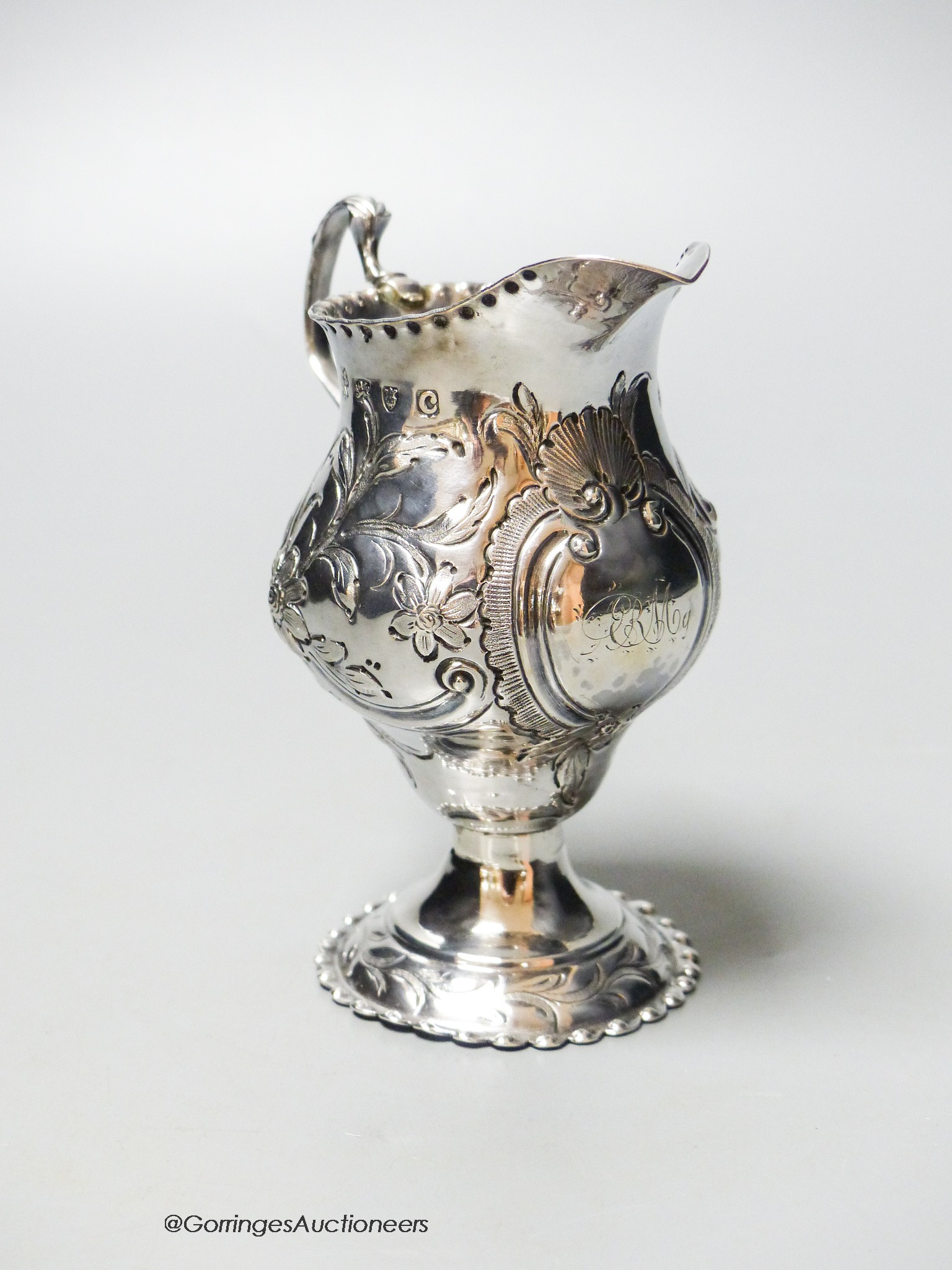 A George III silver helmet cream jug, with later embossed decoration, London, 1778, 10.6cm, 83 grams.